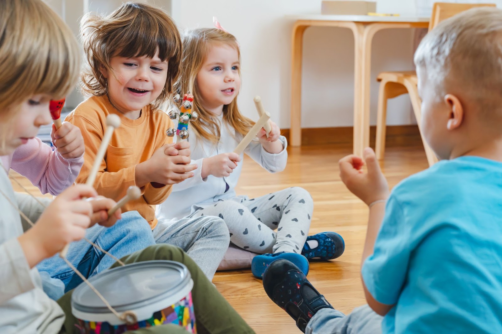 Children joyfully playing instruments in a vibrant classroom, fostering creativity and collaboration