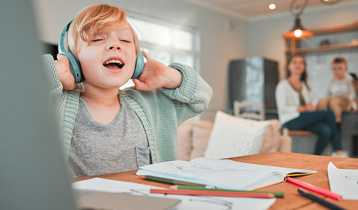 Image Of A Young Boy In Headphones, Enjoying A Family Playlist To Build Closer Relationships